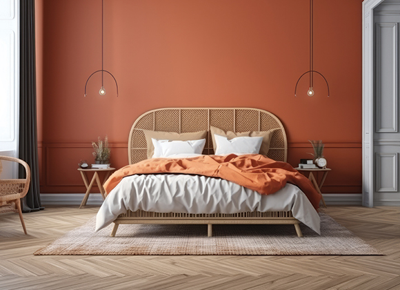 a bedroom with an orange feature wall behind the headboard